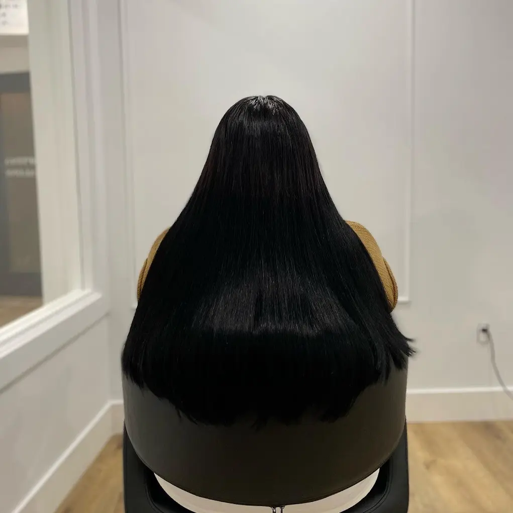 A woman before and after getting black hair extensions, showing a dramatic change in her hairstyle.