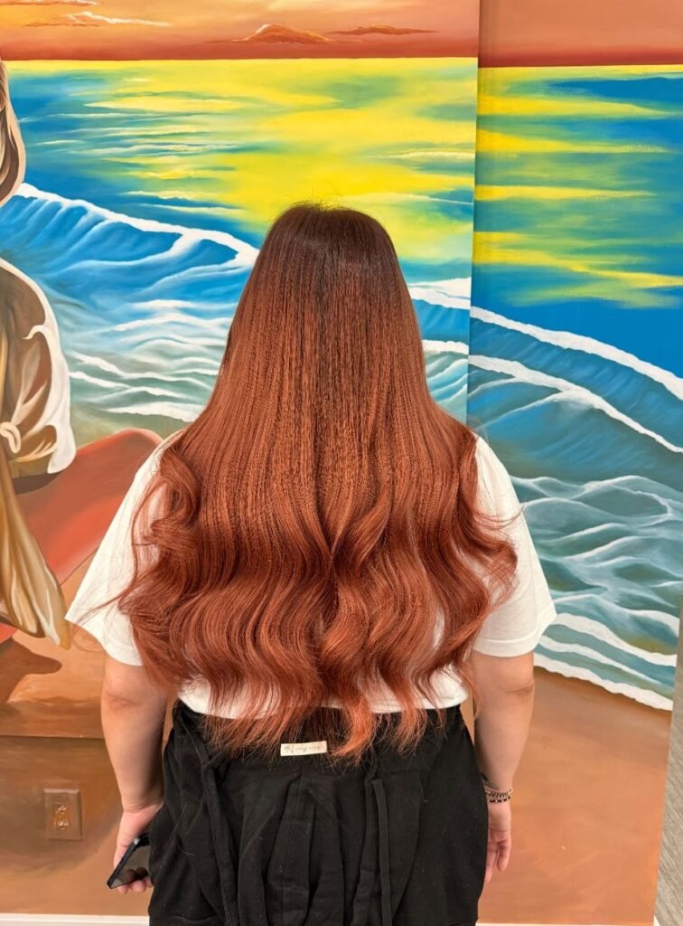 Contact 4 Woman showcasing long, voluminous, and shiny hair after hair extensions installation.